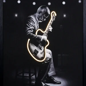 Ilaiyaraaja Guitar LED Wall Decor with Kannada quote and illuminated guitar outline on a monochrome concert stage