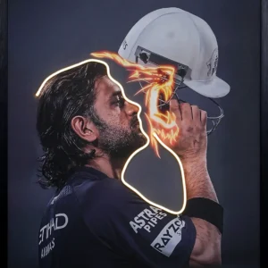 MS Dhoni Nee Singam Dha LED wall art featuring a cricketer's silhouette in profile with glowing gold LED outline and fiery lion design on black background, framed wall decor